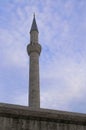 Minaret of KÃâlÃâc Ali Pasha mosque against a blue cloudy sky. Istanbul, Turkey Royalty Free Stock Photo